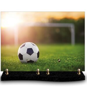 Plaque funéraire personnalisée avec photo d'un ballon de football sur un terrain, sous un soleil couchant. Hommage à un passionné de football, joueur ou supporter